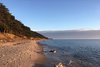 Photo of beach, water and cliiff