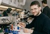 Leonid in the lab using a microscope